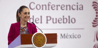 "Conferencia del Pueblo" reads a banner behind President Sheinbaum as she stands at the podium of her morning press conference