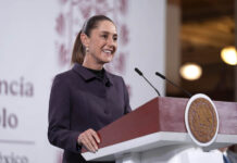 Sheinbaum at a press conference podium