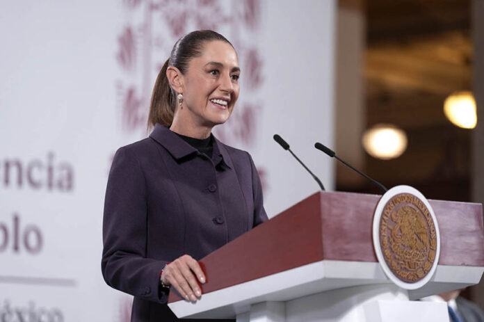 Sheinbaum at a press conference podium