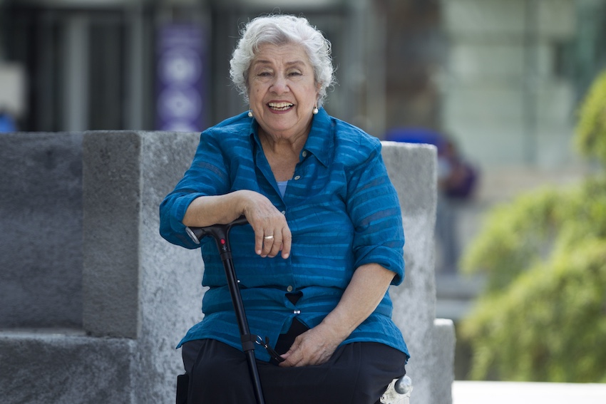 An elderly woman sitting on a bench