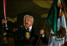 Andres Manuel López Obrador waving a Mexican flag during Mexican Independence Day celebrations