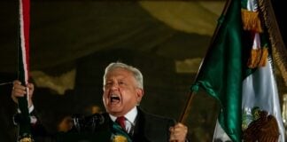 Andres Manuel López Obrador waving a Mexican flag during Mexican Independence Day celebrations