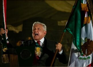 Andres Manuel López Obrador waving a Mexican flag during Mexican Independence Day celebrations