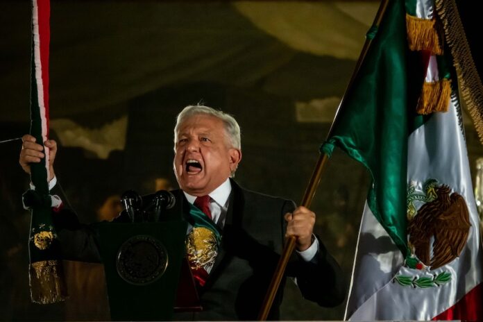 Andres Manuel López Obrador waving a Mexican flag during Mexican Independence Day celebrations