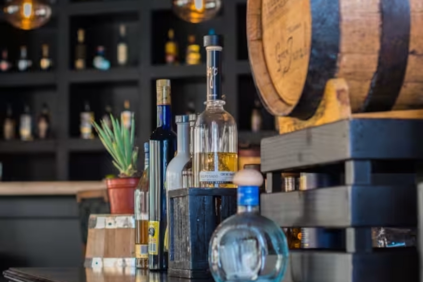 A bottle of tequila on top of a bar