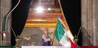 Sheinbaum waving the Mexican flag from the National Palace during the annual Grito de Independencia