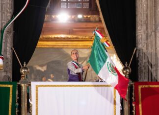 Sheinbaum waving the Mexican flag from the National Palace during the annual Grito de Independencia