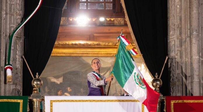 Sheinbaum waving the Mexican flag from the National Palace during the annual Grito de Independencia