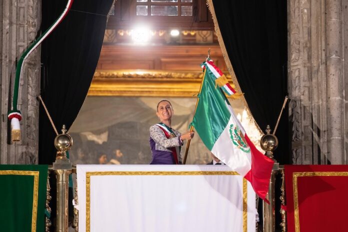 Sheinbaum waving the Mexican flag from the National Palace during the annual Grito de Independencia