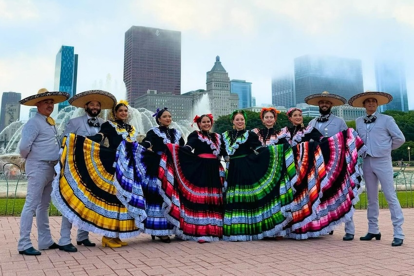 Dancer in traditional Mexican garb against a CHicago skyline background