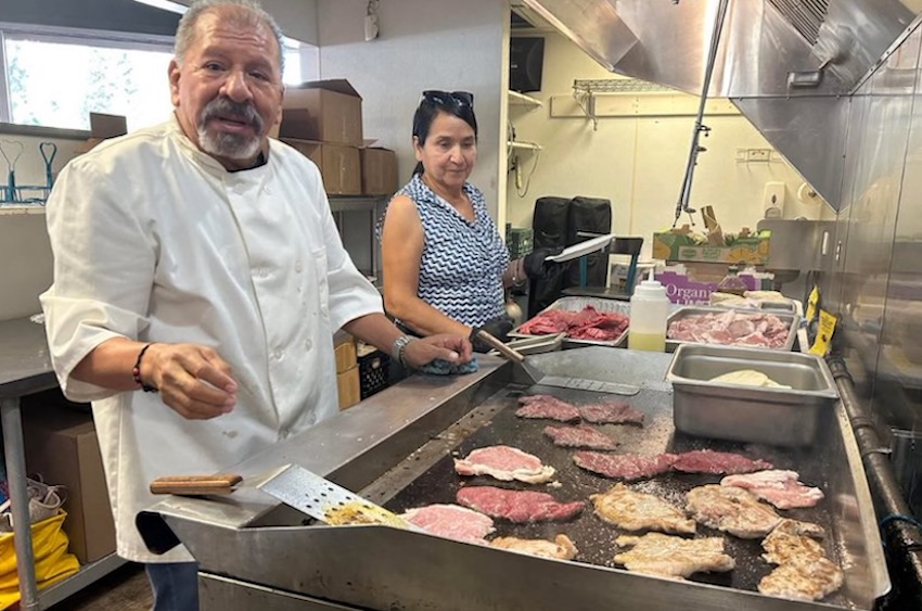 man cooking tacos
