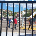 Brown men walk through the US-Mexico border in Nogales
