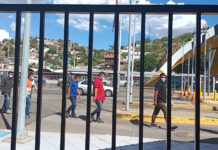 Brown men walk through the US-Mexico border in Nogales