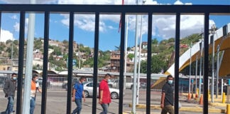 Brown men walk through the US-Mexico border in Nogales
