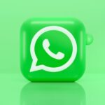WhatsApp logo on bright green background with bubbles.