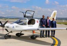 three men in front of the Halcón aircraft