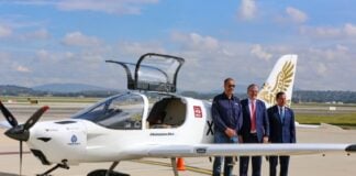 three men in front of the Halcón aircraft
