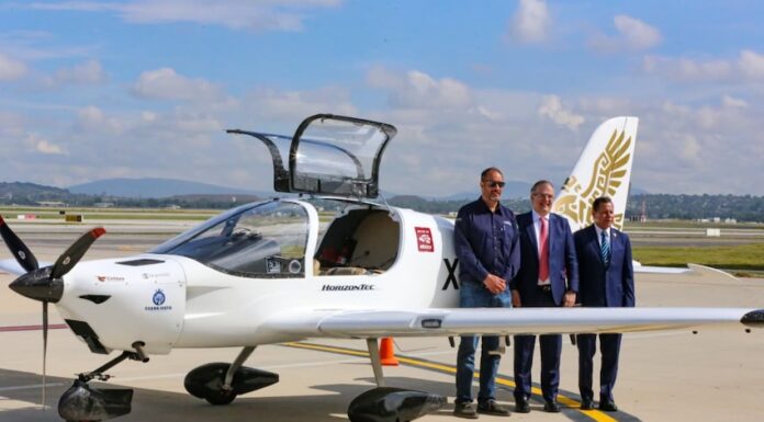 three men in front of the Halcón aircraft