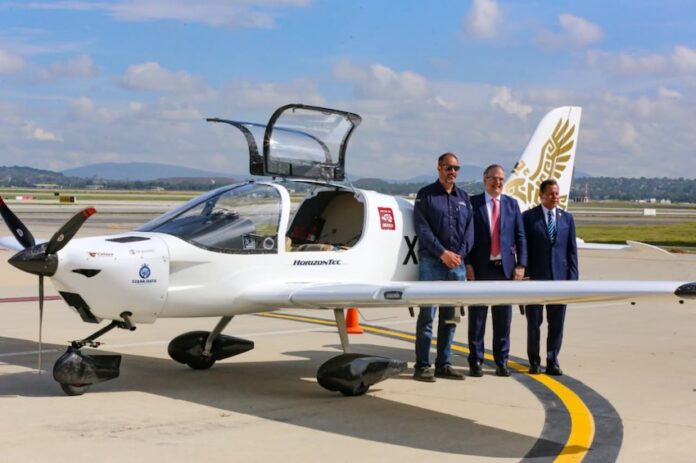 three men in front of the Halcón aircraft