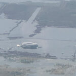 an aerial photo shows the terminal of Mexico City's canceled airport sinking into Lake Texcoco