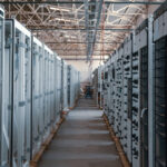 A long hallway between servers in a data center