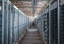 A long hallway between servers in a data center