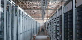 A long hallway between servers in a data center