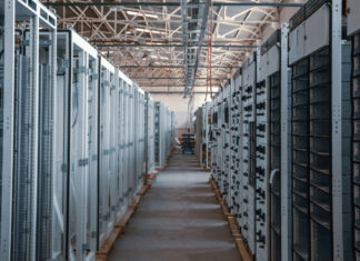 A long hallway between servers in a data center