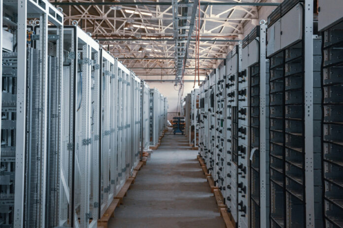 A long hallway between servers in a data center