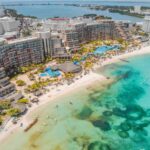 An aerial view of massive hotels on the white sand beaches of Cancún
