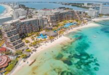 An aerial view of massive hotels on the white sand beaches of Cancún