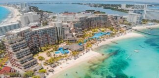 An aerial view of massive hotels on the white sand beaches of Cancún