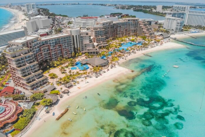 An aerial view of massive hotels on the white sand beaches of Cancún