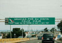 "Gracias por su visita, feliz viaje" reads a sign over a Mexican highway