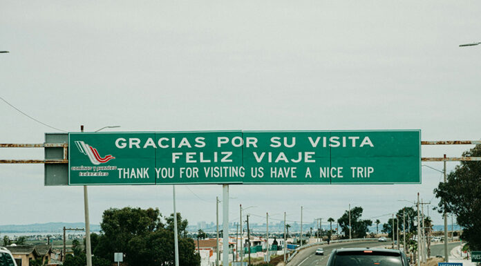 "Gracias por su visita, feliz viaje" reads a sign over a Mexican highway