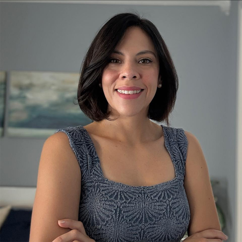 A woman smiles at the camera