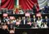 Opposition politicans in hold up protest signs in the Mexican senate