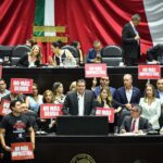Opposition politicans in hold up protest signs in the Mexican senate