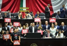 Opposition politicans in hold up protest signs in the Mexican senate