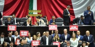 Opposition politicans in hold up protest signs in the Mexican senate