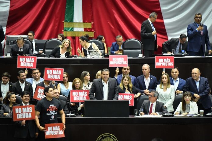 Opposition politicans in hold up protest signs in the Mexican senate