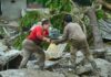 People offering each other help in a flood scenario
