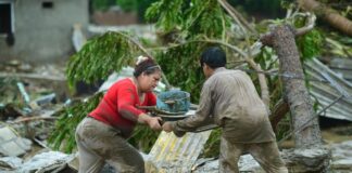 People offering each other help in a flood scenario