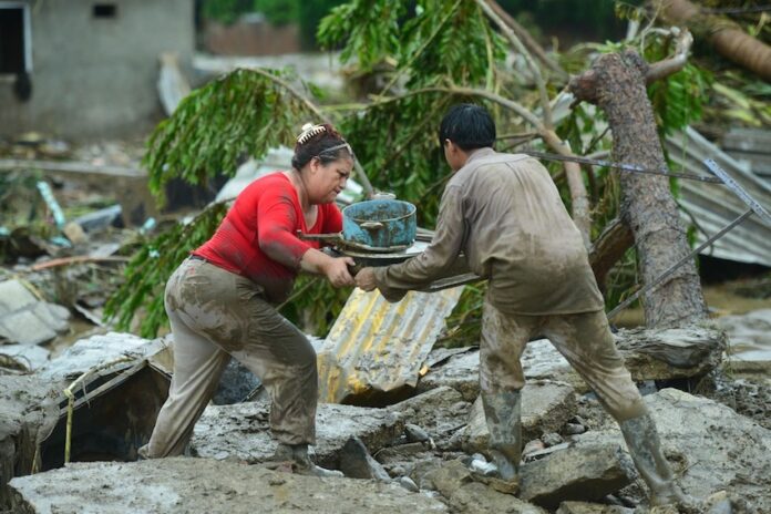 People offering each other help in a flood scenario