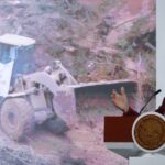 Sheinbaum and graphic of machinery