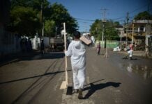 Power fully restored to flood-hit communities, 70,000 homes to receive aid A sanitation worker delivers aid in flood-stricken Veracruz, Mexico