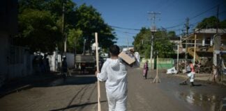 A sanitation worker delivers aid in flood-stricken Veracruz, Mexico