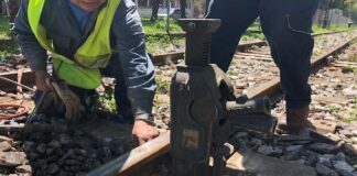 a person laying train tracks