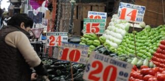 Vegetable prices displayed at a Mexican market