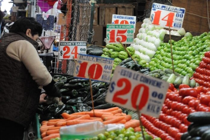 Vegetable prices displayed at a Mexican market